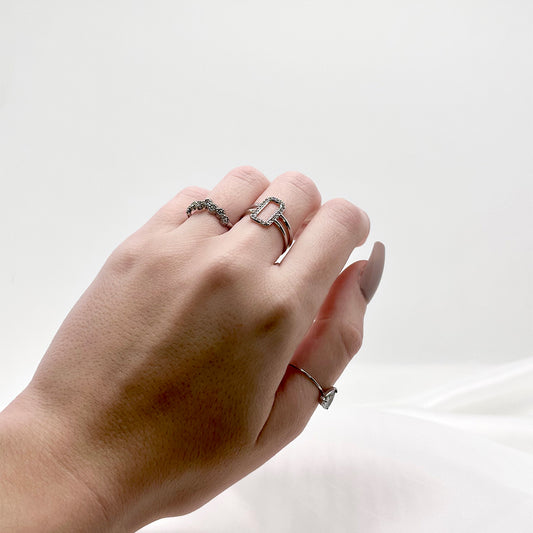 Bague réglable argentée en acier inoxydable avec des petites pierres avec une bague argentée avec un petit cadre en strass et avec un solitaire argenté de Jeana Jewelry