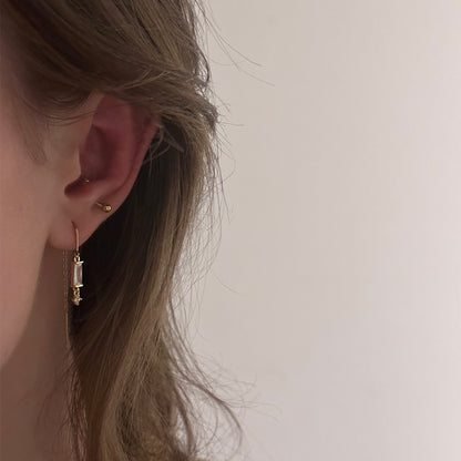 Boucle d'oreille dorée en acier inoxydable qui pend avec un diamant de Jeana Jewelry